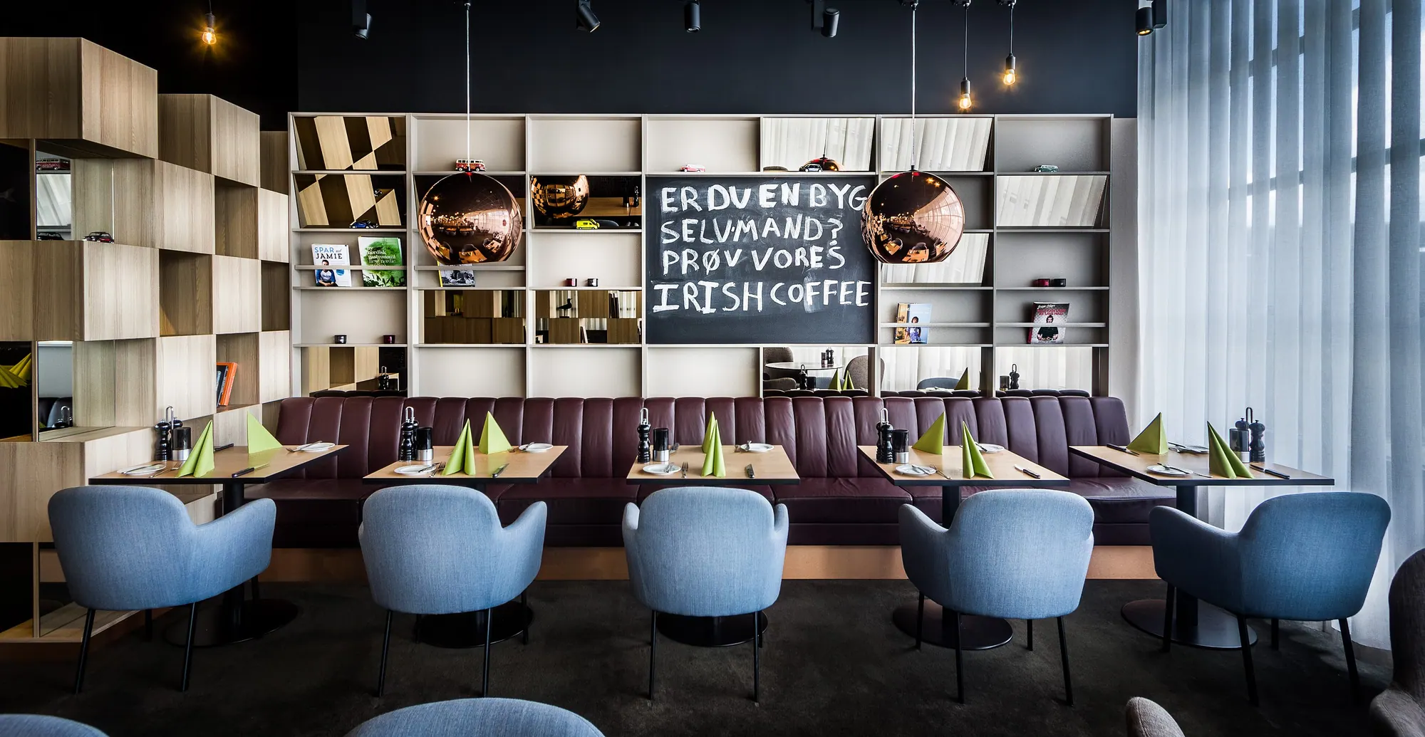 Banquette seating under brass pendants